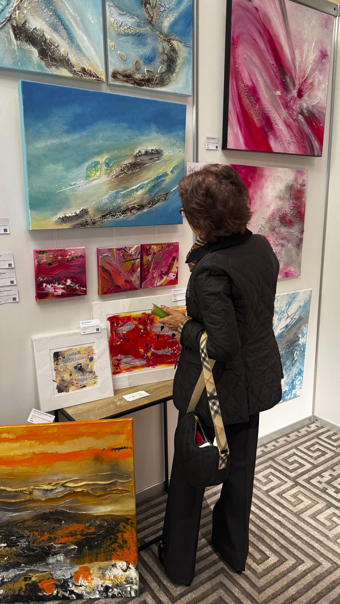 Close view of textured abstract paintings with layered surfaces at ART.CY 2026