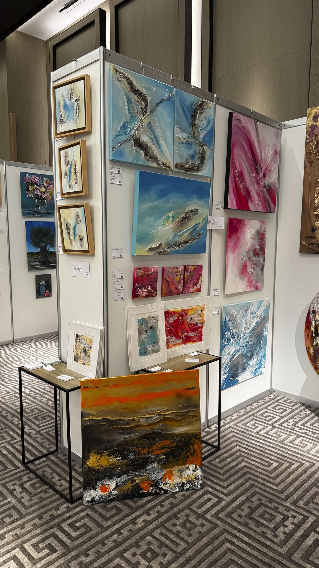 Artist booth with abstract mixed media paintings at ART.CY 2026 Limassol
